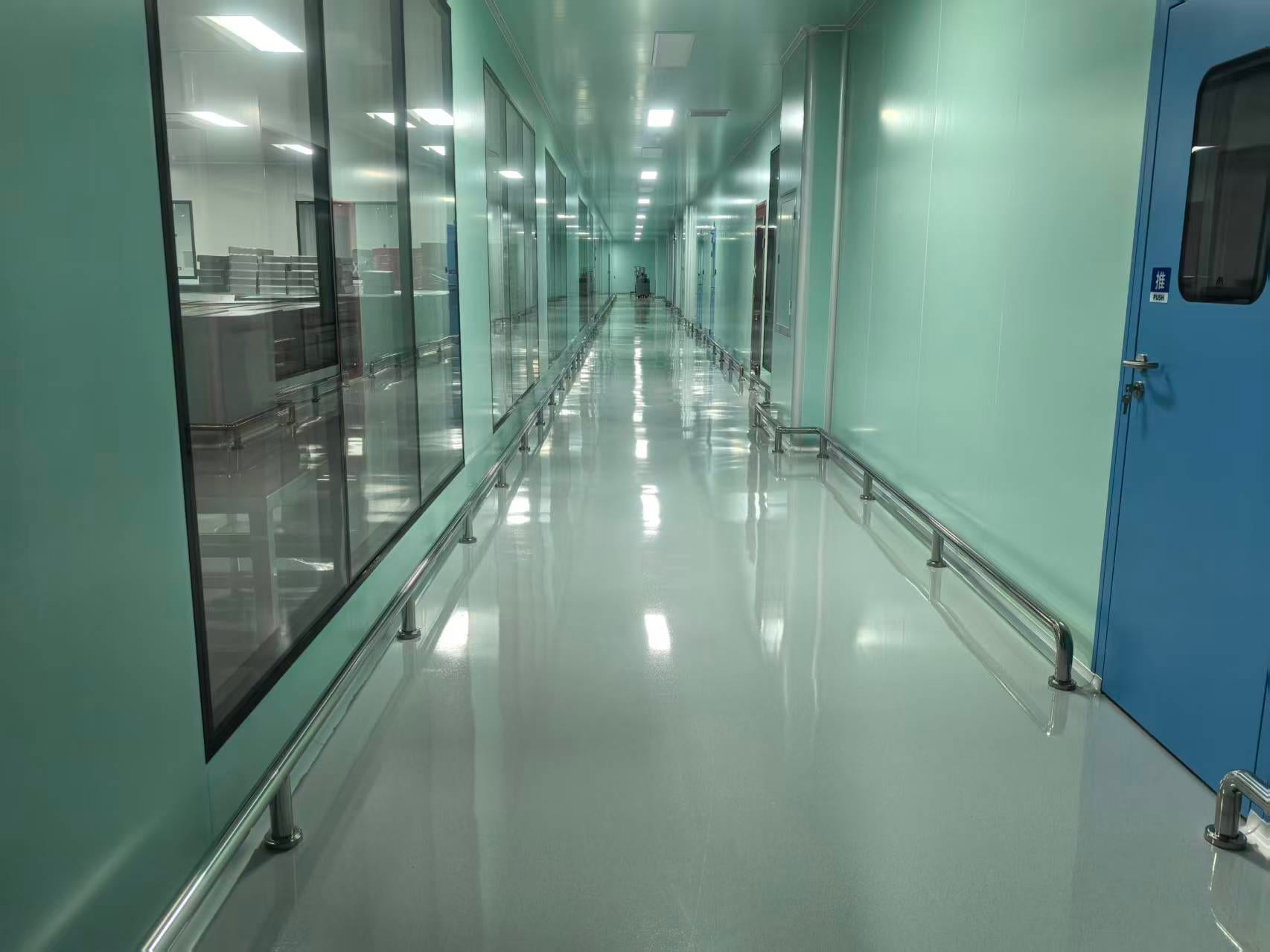 GMP cleanroom corridor with glass viewing panels and hygienic flooring
